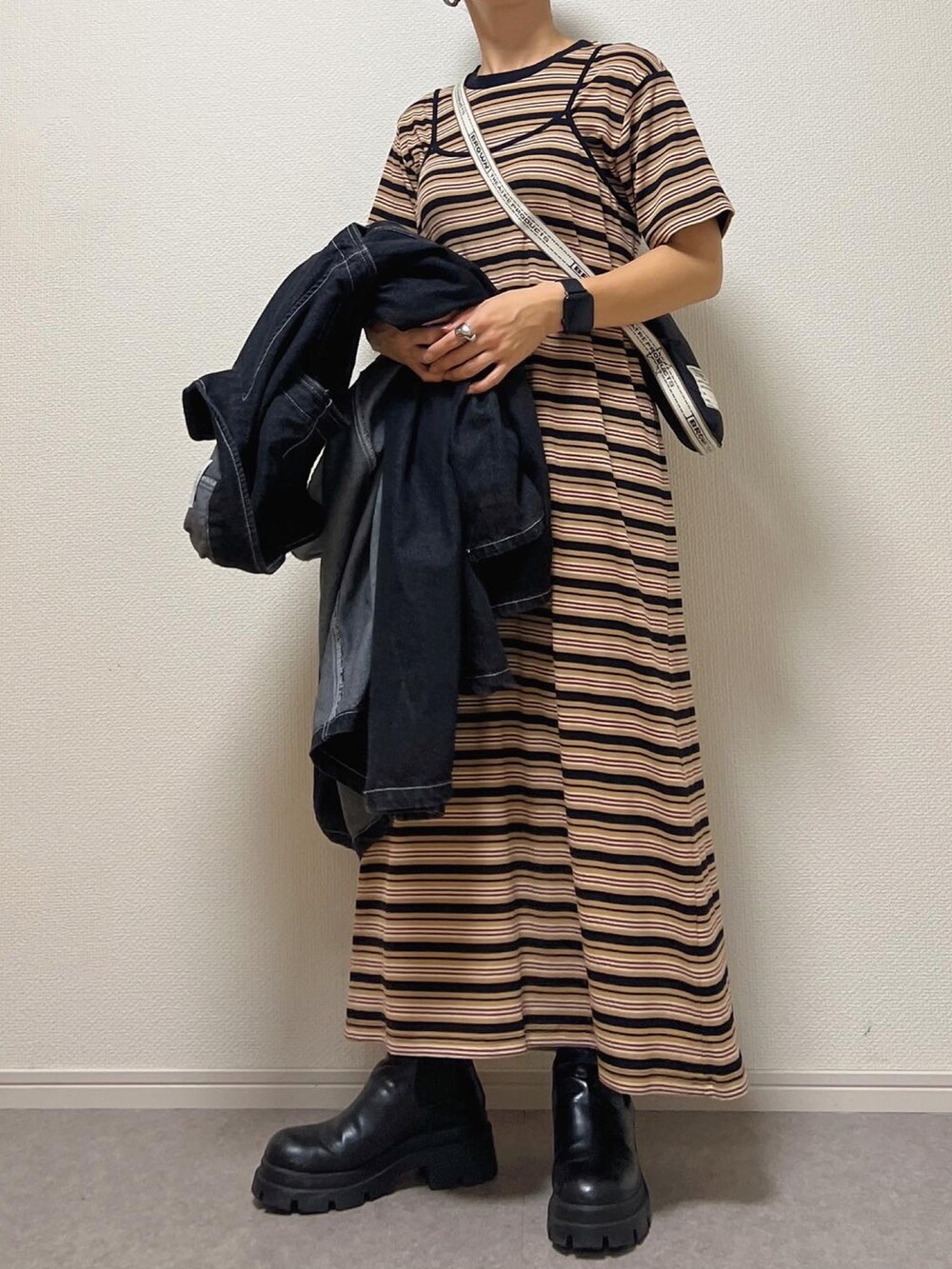 ブラック系のワンピース、ブラック系のショルダーバッグを着用したレディースの夏コーディネートの2枚目の写真