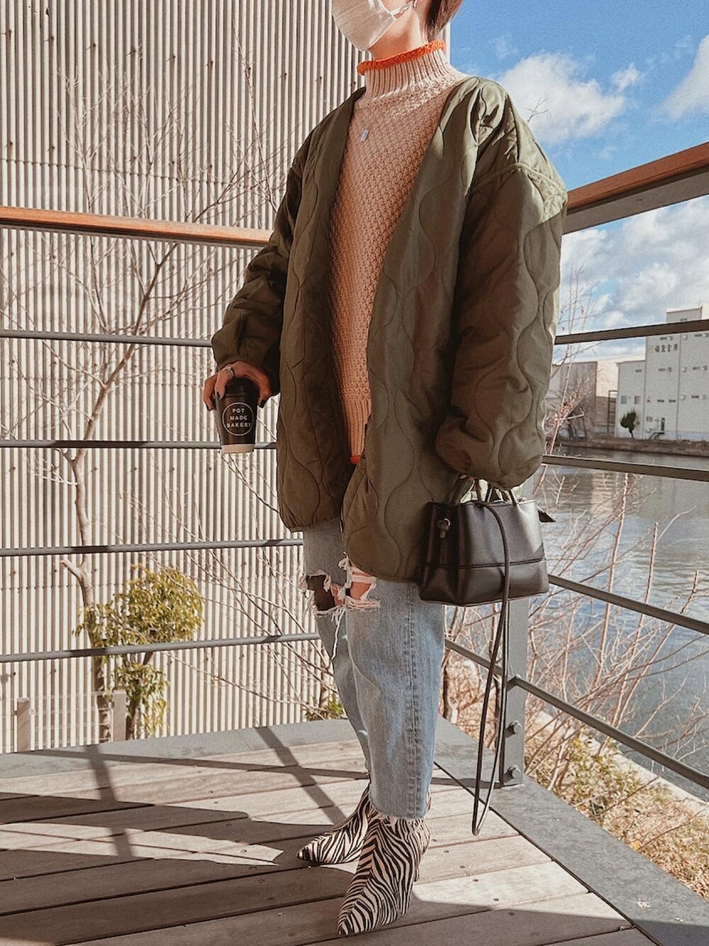 ベージュ系のニット/セーター、その他のブーツを着用したレディースの冬コーディネートの2枚目の写真