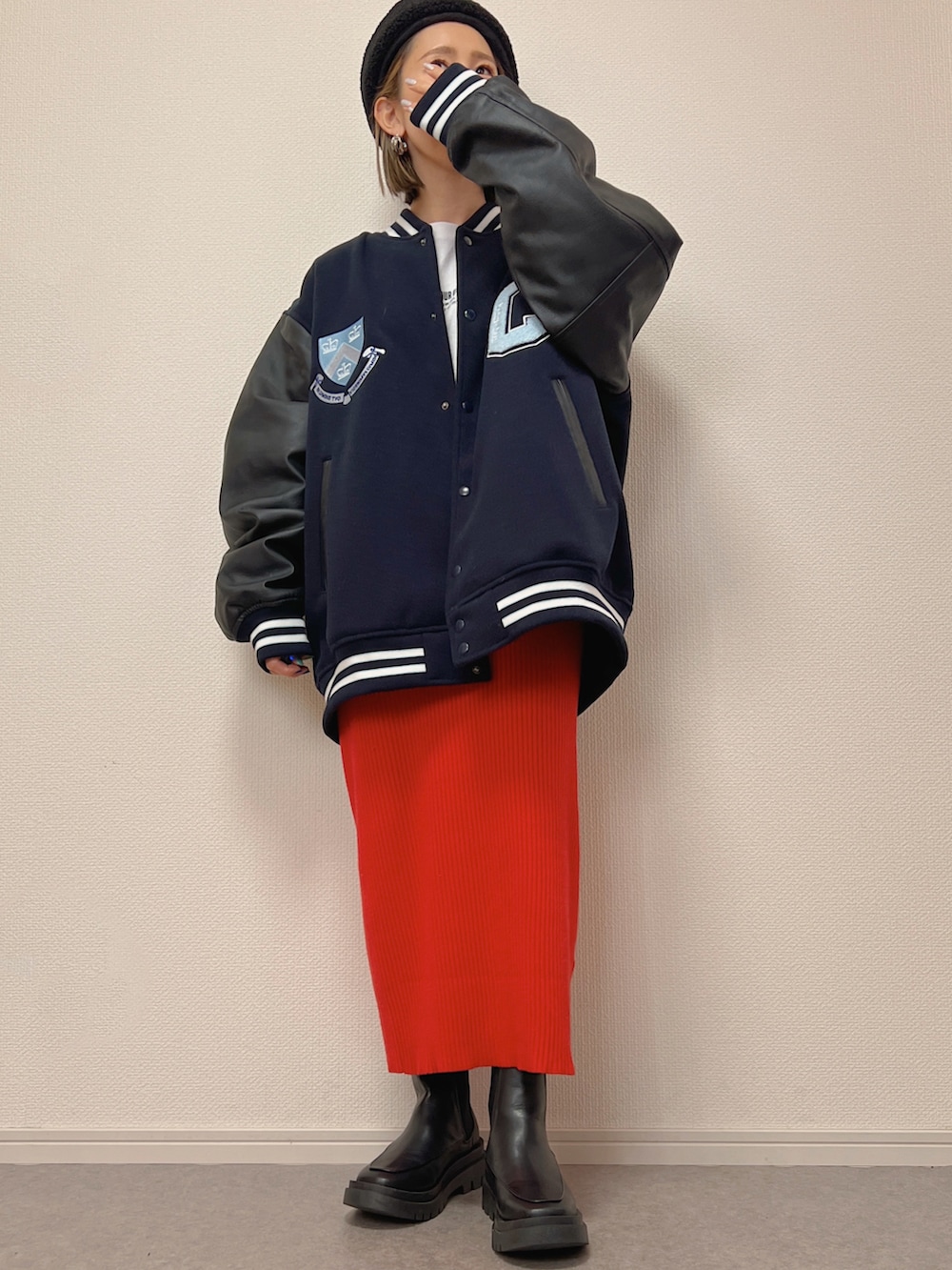 ブルー系のスタジャン、ホワイト系のブーツ、レッド系のスカートを着用したレディースの冬コーディネートの2枚目の写真