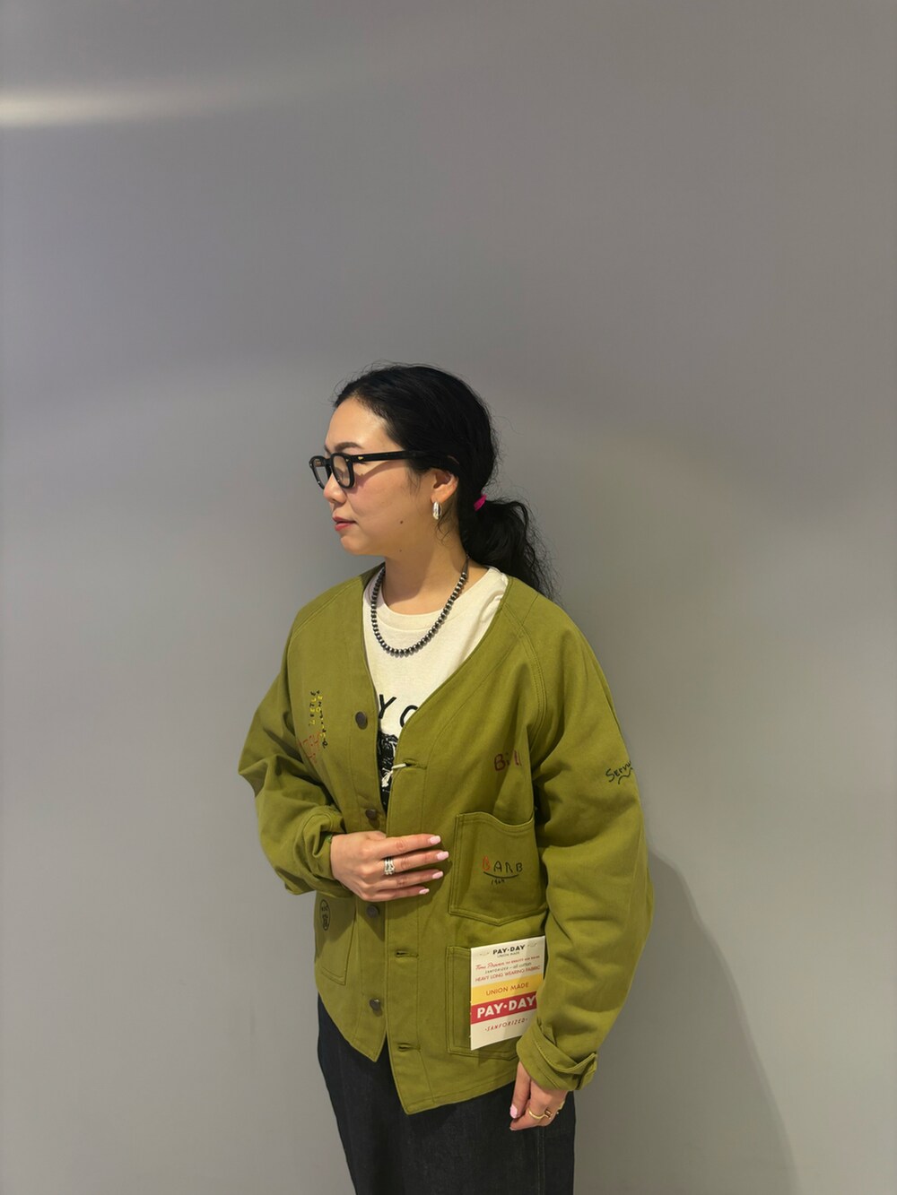 ブルー系のデニムパンツ、ブラック系のローファー、ベージュ系のTシャツ/カットソーを着用したレディースの夏コーディネートの2枚目の写真