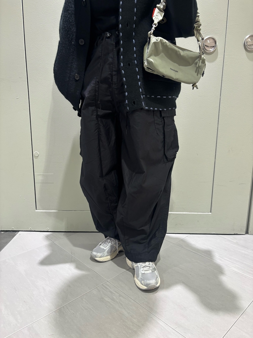 ブラック系のカーディガン/ボレロ、グレー系のショルダーバッグを着用したレディースの秋コーディネートの3枚目の写真