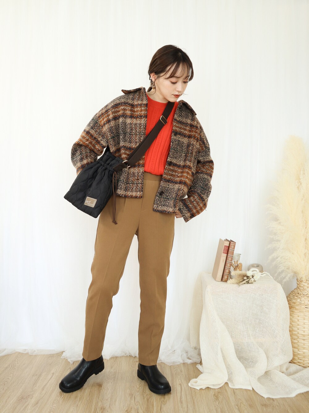 ブラウン系のジャケット/アウター、オレンジ系のニット/セーター、ベージュ系のパンツを着用したレディースの秋コーディネートの2枚目の写真
