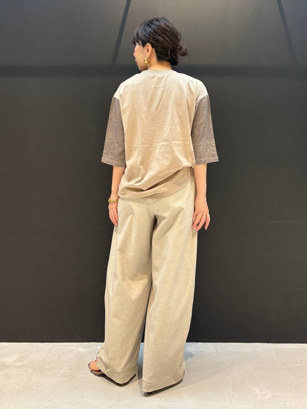 ベージュ系のその他パンツ、ブラウン系のTシャツ/カットソー、ゴールド系のピアス（両耳用）を着用したレディースの夏コーディネートの4枚目の写真