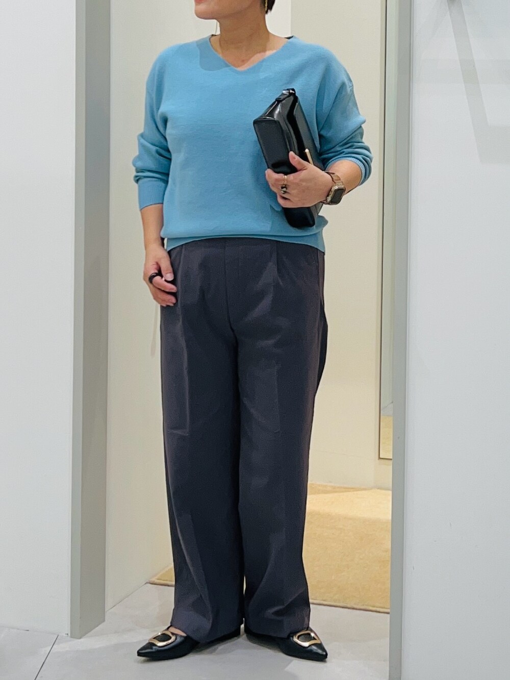 ブルー系のニット/セーター、ブラック系のショルダーバッグ、ブラック系のパンプスを着用したレディースの秋コーディネートの5枚目の写真