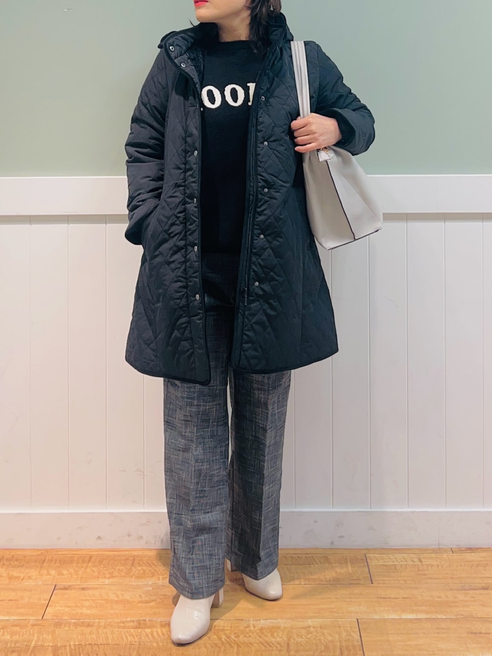 ブラック系のニット/セーター、ブラック系のその他アウター、グレー系のトートバッグを着用したレディースの冬コーディネートの4枚目の写真