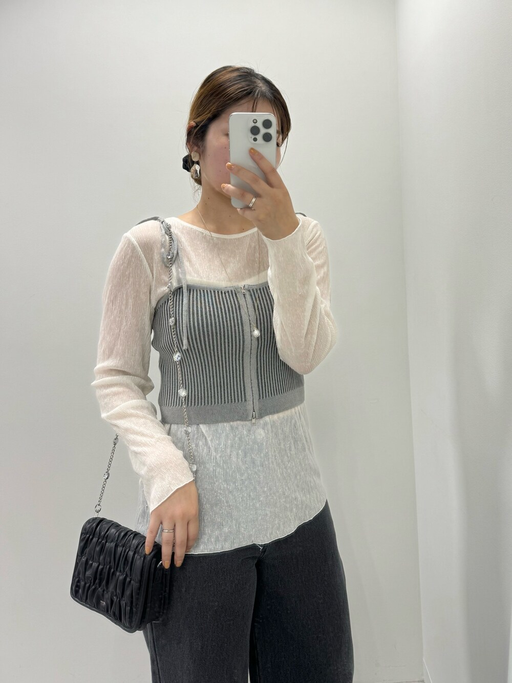 グレー系のニット/セーター、ブラック系のデニムパンツ、シルバー系のサンダルを着用したレディースの夏コーディネートの2枚目の写真