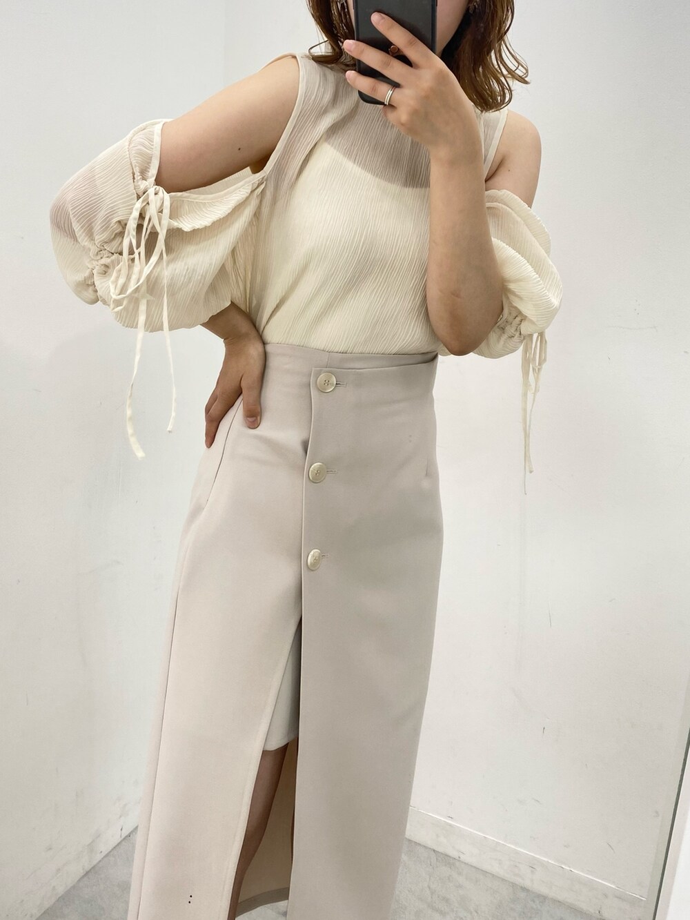 ホワイト系のシャツ/ブラウス、ベージュ系のスカート、ベージュ系のサンダルを着用したレディースの夏コーディネートの4枚目の写真