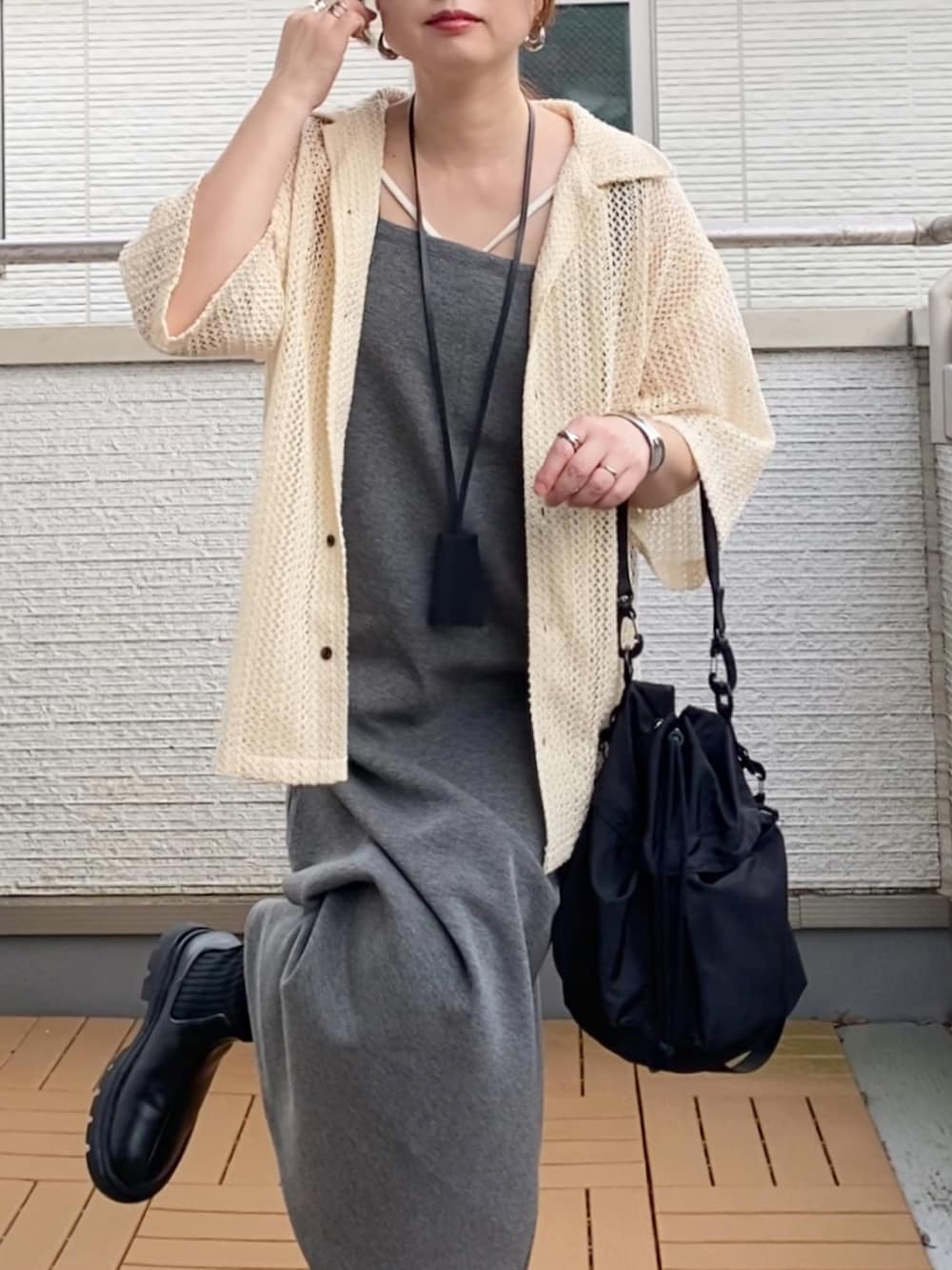 グレー系のワンピース、ホワイト系のシャツ/ブラウス、ブラック系のブーツを着用したレディースの夏コーディネートの4枚目の写真