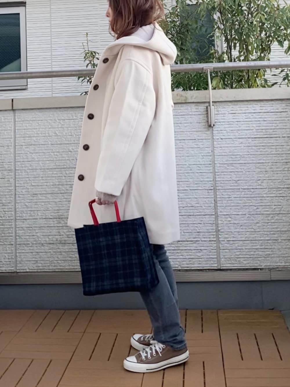 ホワイト系のその他アウター、グレー系のカーディガン/ボレロ、グレー系のデニムパンツを着用したレディースの冬コーディネートの2枚目の写真