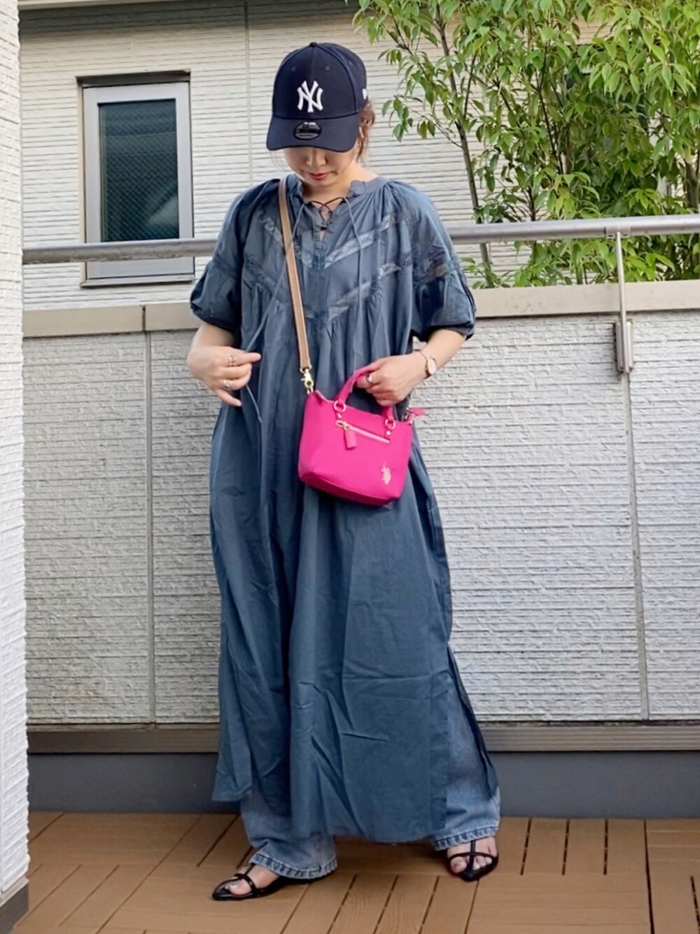 ブルー系のワンピース、ブルー系のデニムパンツ、ピンク系のショルダーバッグを着用したレディースの夏コーディネートの3枚目の写真