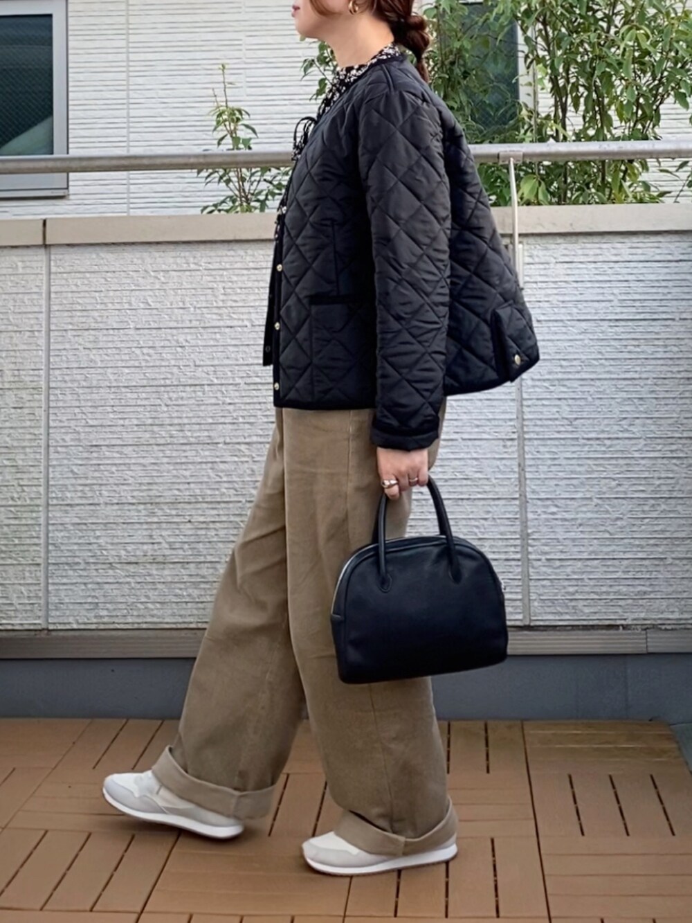ブラック系のノーカラージャケット、ブラック系のシャツ/ブラウス、ベージュ系のその他パンツを着用したレディースの秋コーディネートの3枚目の写真