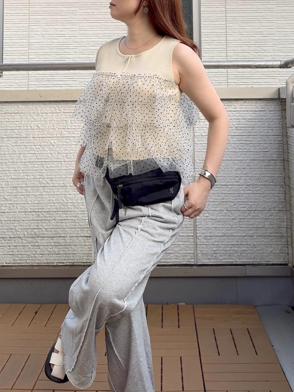 ホワイト系のニット/セーター、グレー系のスウェットパンツ、ブラック系のボディバッグ/ウエストポーチを着用したレディースの夏コーディネートの4枚目の写真