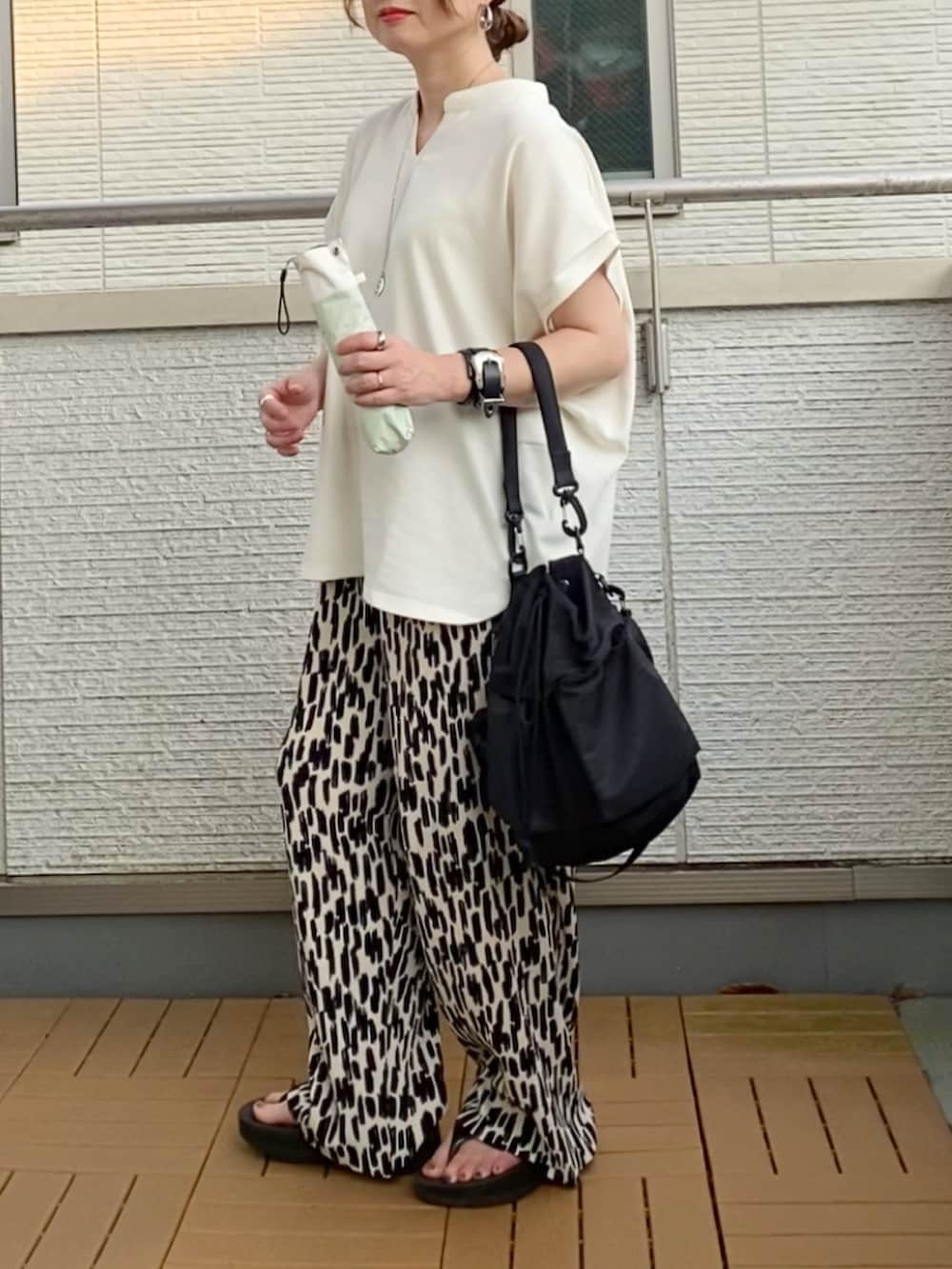 ホワイト系のTシャツ/カットソー、ホワイト系のその他パンツ、ブラック系のショルダーバッグを着用したレディースの夏コーディネートの4枚目の写真