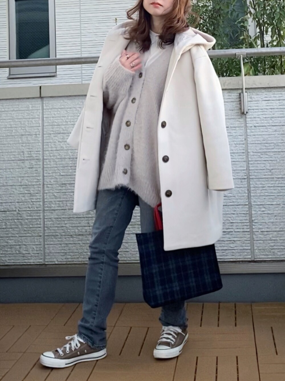 ホワイト系のその他アウター、グレー系のカーディガン/ボレロ、グレー系のデニムパンツを着用したレディースの冬コーディネートの3枚目の写真