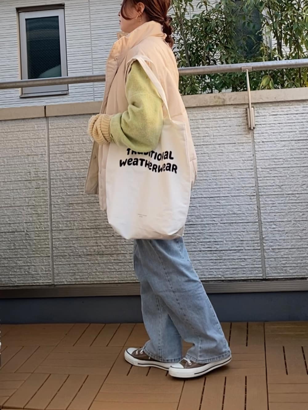 グリーン系のカーディガン/ボレロ、ホワイト系のダウンジャケット/コート、ホワイト系のTシャツ/カットソーを着用したレディースの冬コーディネートの3枚目の写真