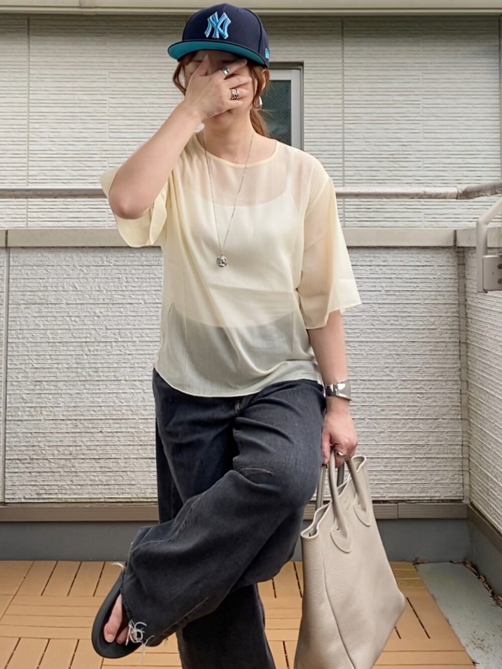 ホワイト系のシャツ/ブラウス、ブラック系のデニムパンツ、ベージュ系のトートバッグを着用したレディースの夏コーディネートの4枚目の写真