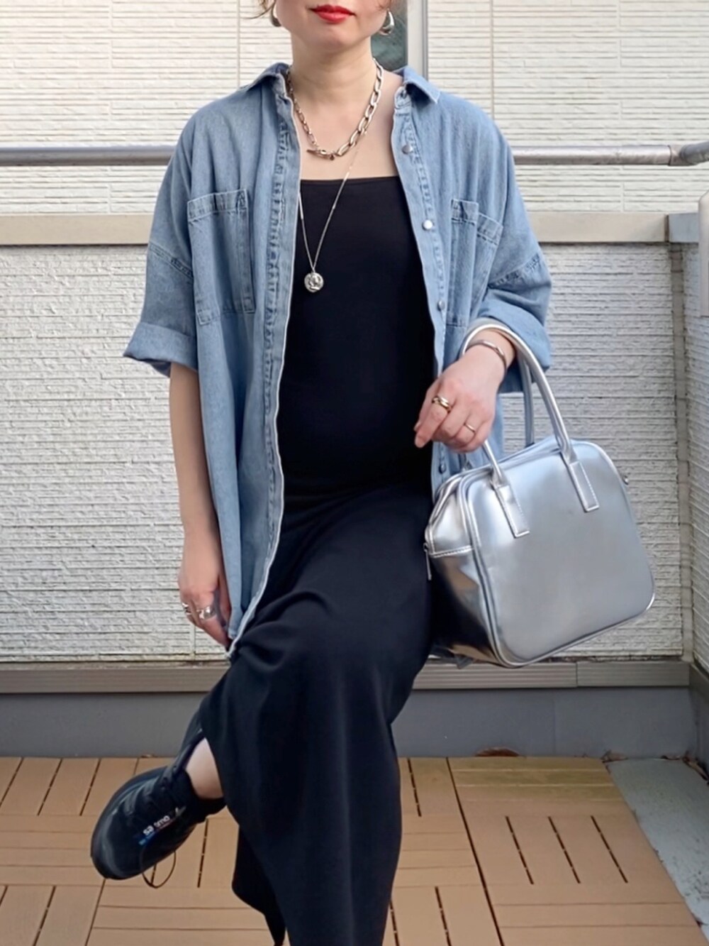 ブルー系のシャツ/ブラウス、ブラック系のワンピース、シルバー系のボストンバッグを着用したレディースの夏コーディネートの4枚目の写真
