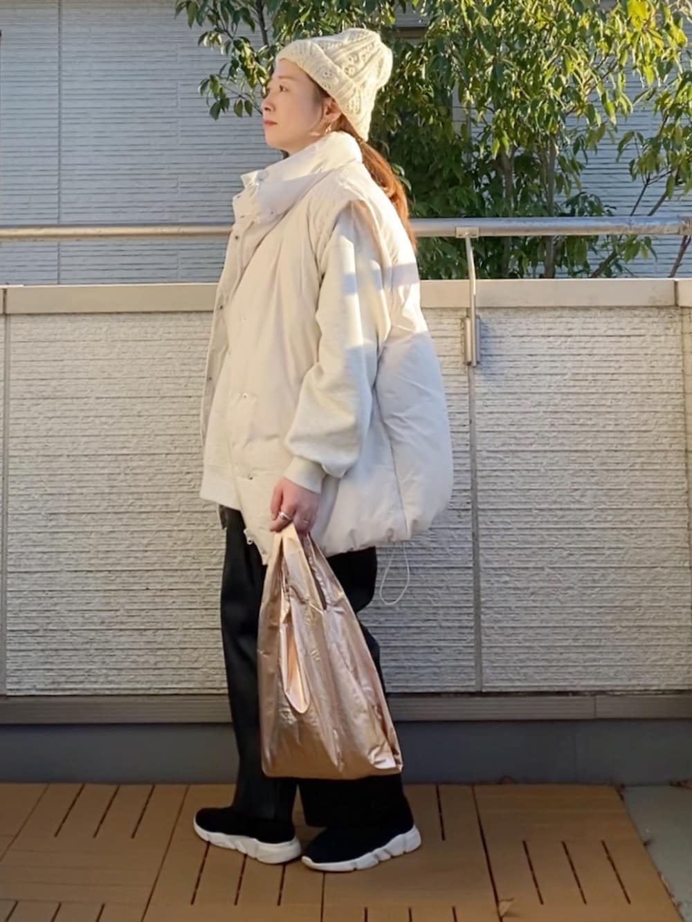 ホワイト系のダウンジャケット/コート、グレー系のスウェット、ブラック系のその他パンツを着用したレディースの冬コーディネートの2枚目の写真