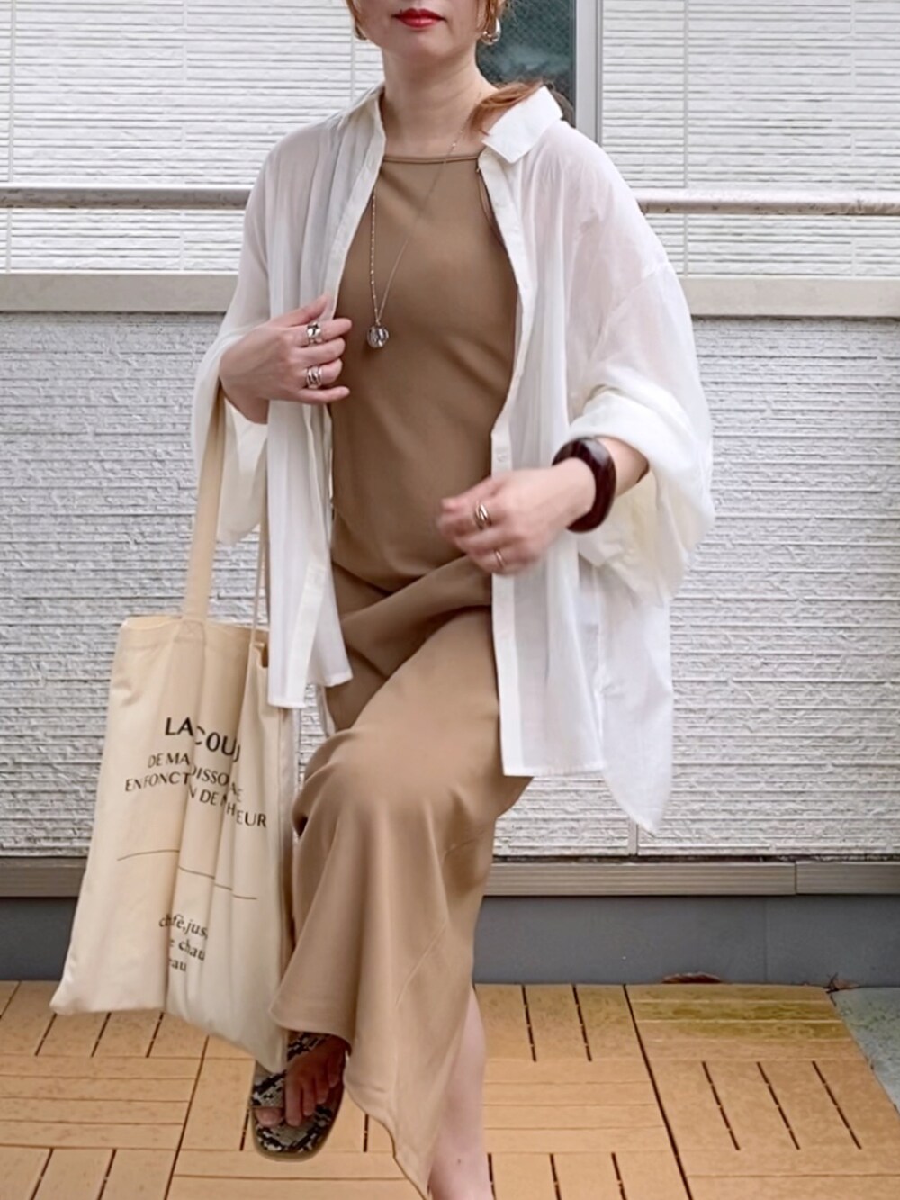 ホワイト系のシャツ/ブラウス、ベージュ系のワンピース、ホワイト系のトートバッグを着用したレディースの夏コーディネートの4枚目の写真