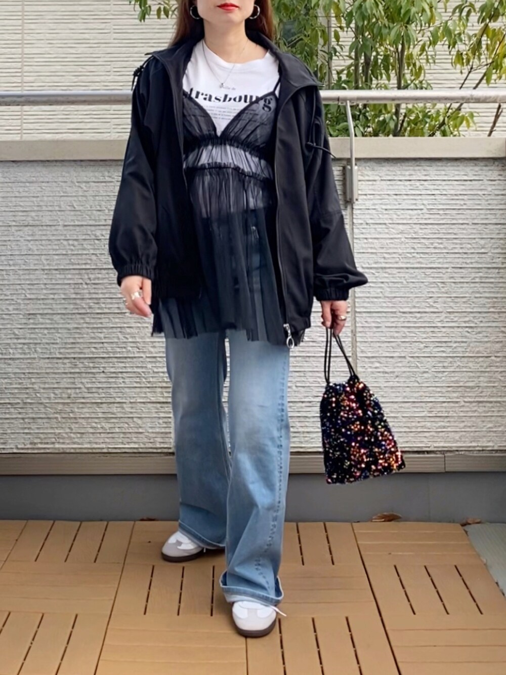 ブラック系のキャミソール、ホワイト系のTシャツ/カットソー、ブラック系のナイロンジャケットを着用したレディースの春コーディネートの5枚目の写真