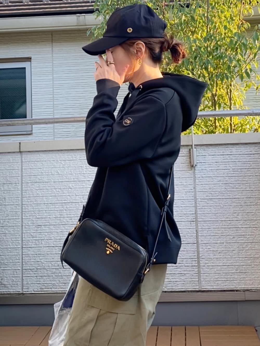 ブラック系のパーカー、ベージュ系のカーゴパンツ、その他のエコバッグ/サブバッグを着用したレディースの秋コーディネートの4枚目の写真