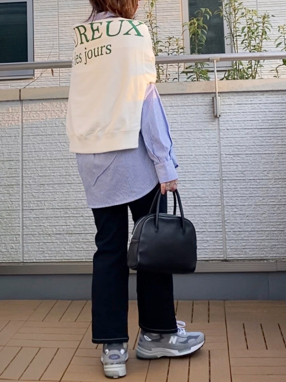 ブルー系のシャツ/ブラウス、ホワイト系のTシャツ/カットソー、ブラック系のデニムパンツを着用したレディースの春コーディネートの3枚目の写真