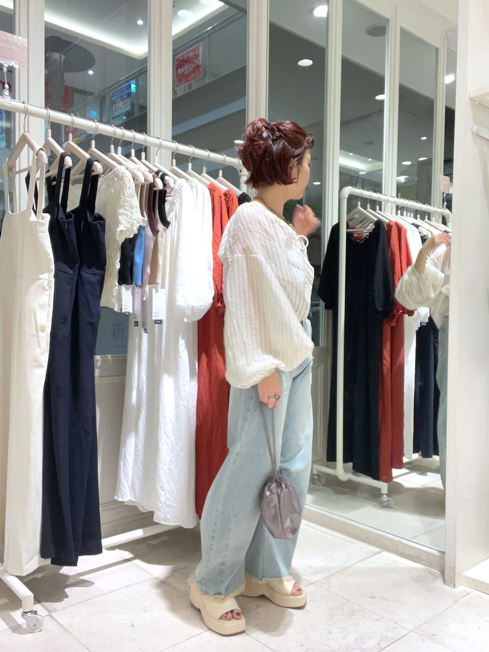 ベージュ系のシャツ/ブラウス、ブルー系のデニムパンツ、ホワイト系のサンダルを着用したレディースの夏コーディネートの3枚目の写真