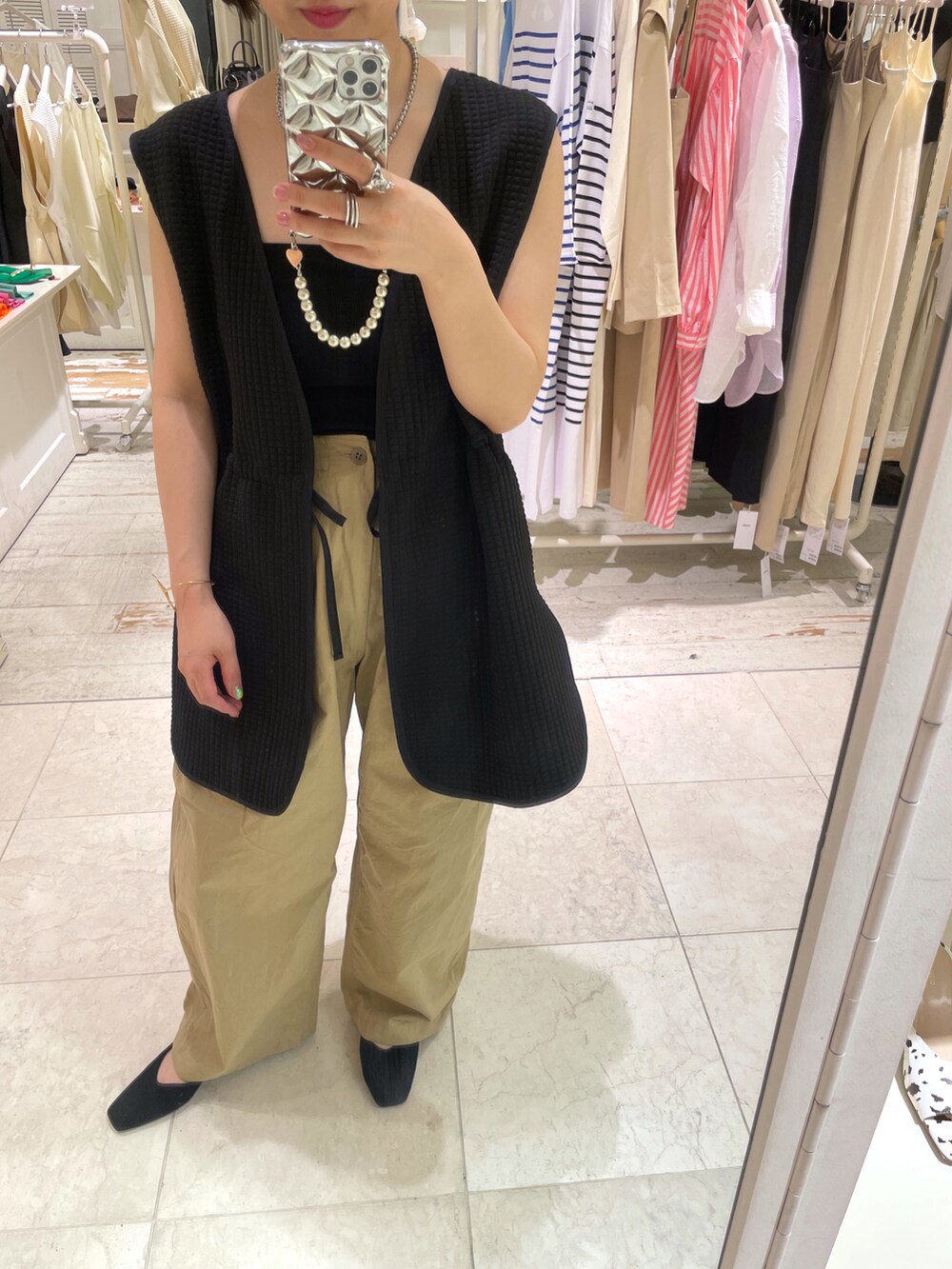 ブラック系のTシャツ/カットソー、ベージュ系のチノパンツを着用したレディースの夏コーディネートの4枚目の写真