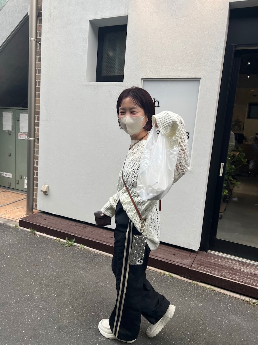 ホワイト系のニット/セーター、ブラック系のその他パンツを着用したレディースの春コーディネートの3枚目の写真