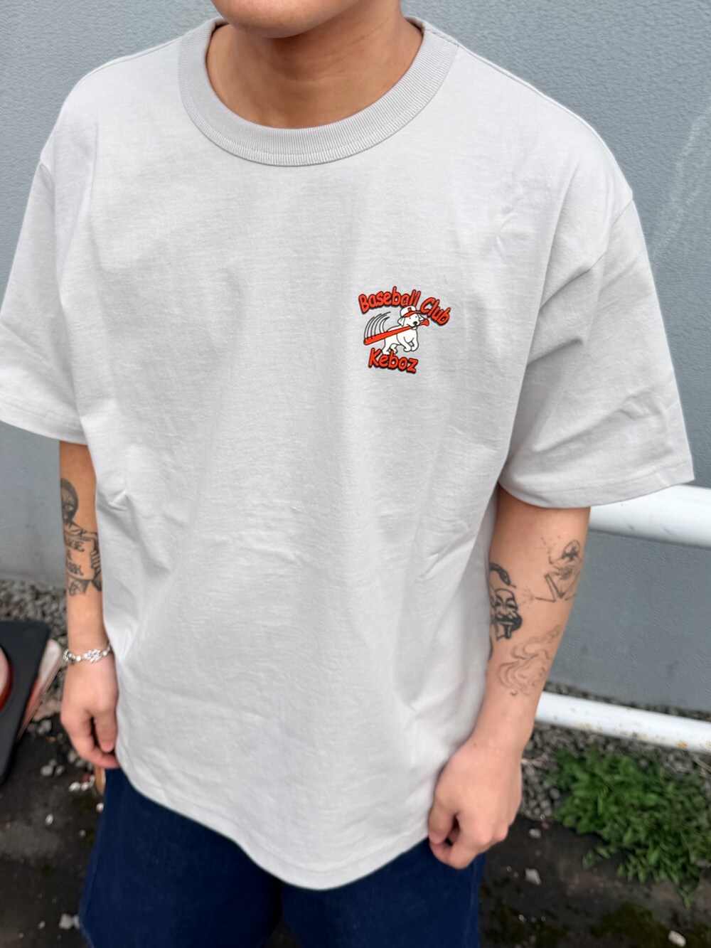 グレー系のTシャツ/カットソー、ブルー系のデニムパンツを着用したメンズの春コーディネートの3枚目の写真