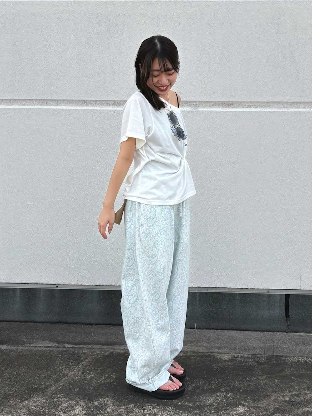 ブルー系のデニムパンツ、ホワイト系のTシャツ/カットソー、グレー系のサングラスを着用したレディースの夏コーディネートの3枚目の写真