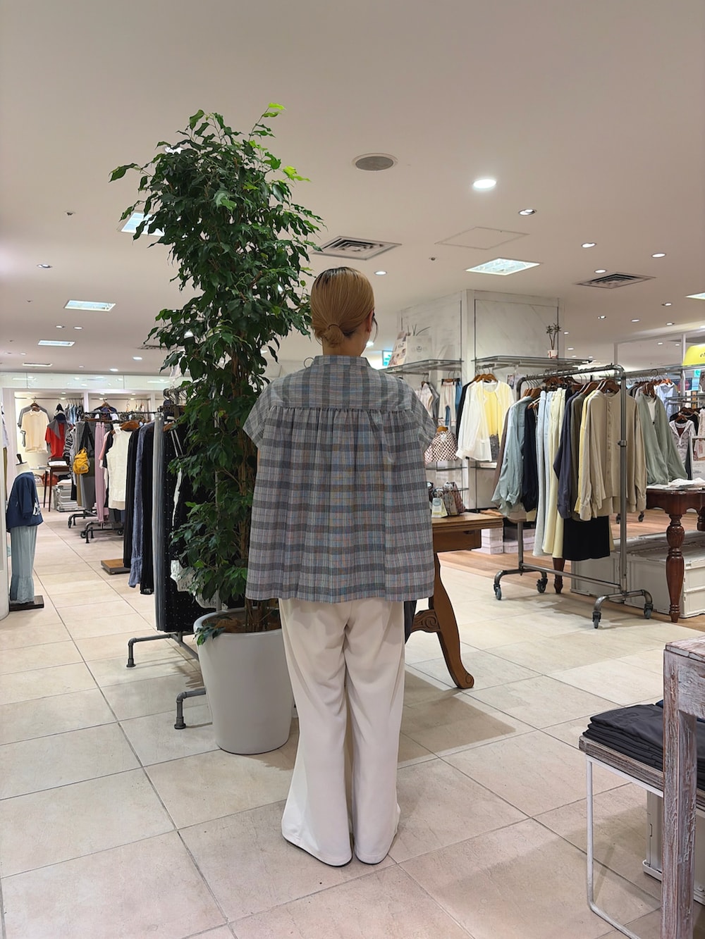 ブラック系のシャツ/ブラウス、ホワイト系のスラックス、グレー系のトートバッグを着用したレディースの春コーディネートの2枚目の写真