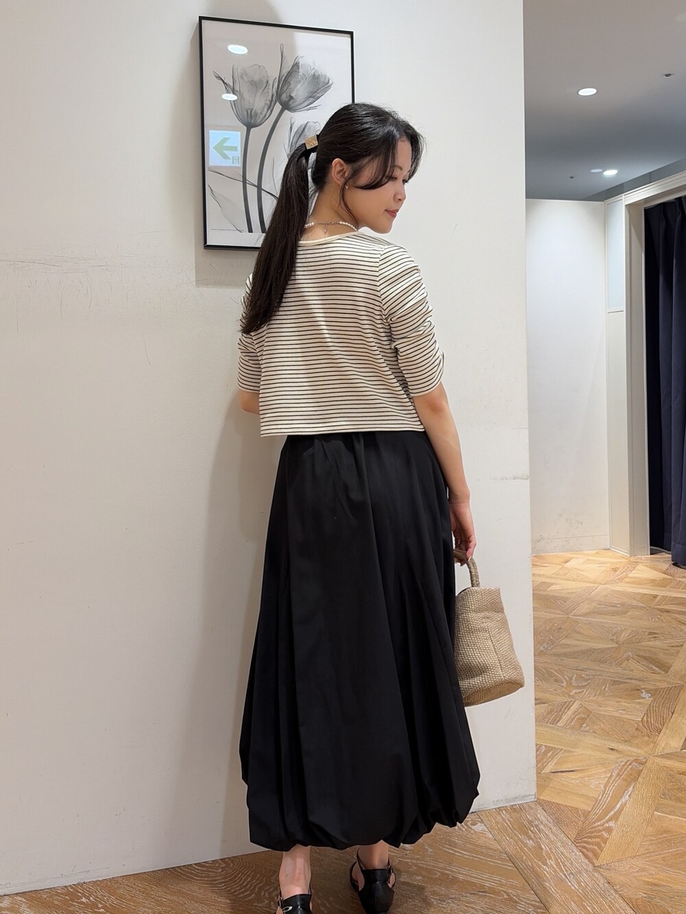 ホワイト系のTシャツ/カットソー、ブラック系のスカート、ベージュ系のショルダーバッグを着用したレディースの夏コーディネートの5枚目の写真