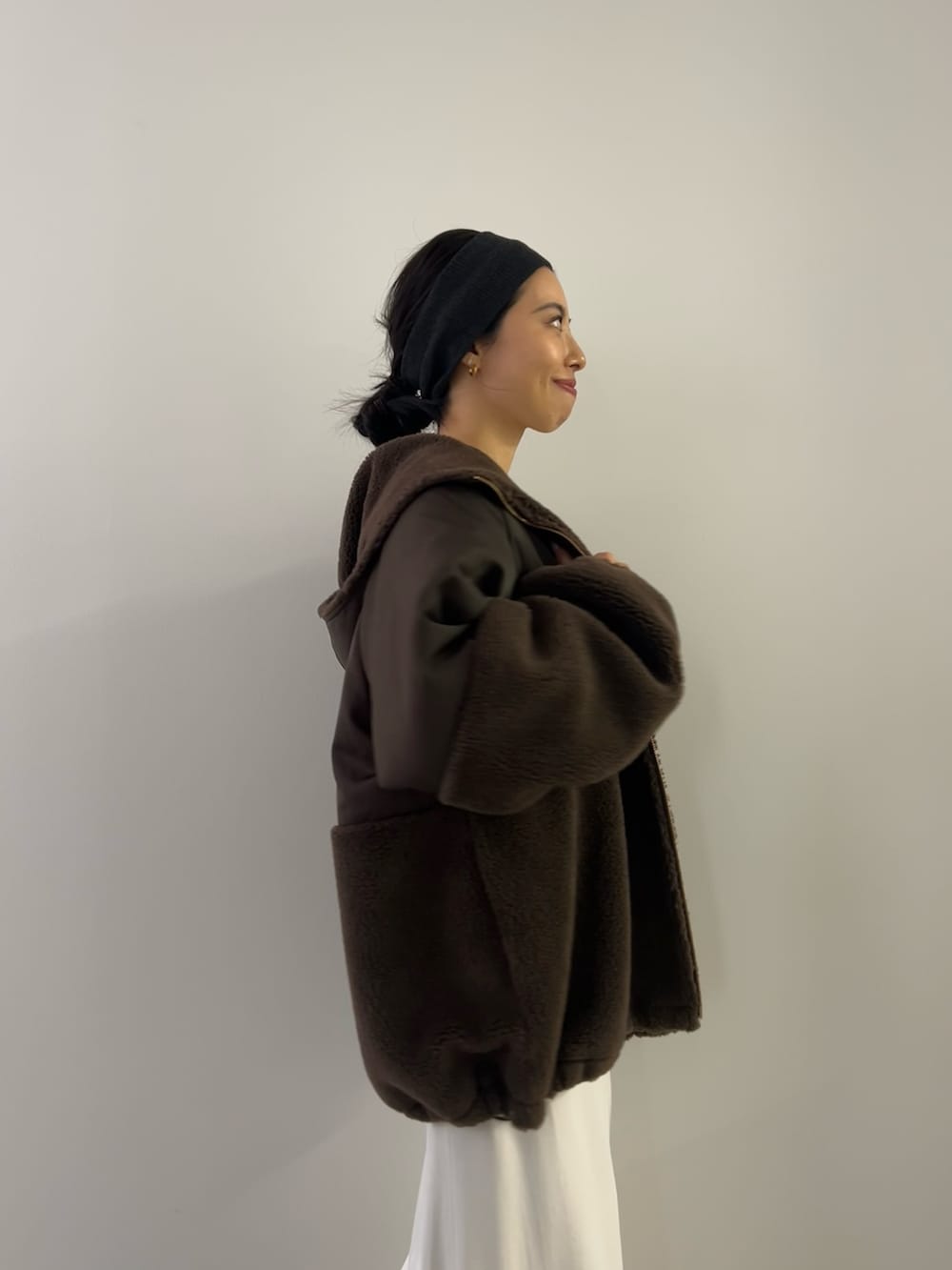 ホワイト系のニット/セーター、ホワイト系のスカート、ブラウン系のブルゾンを着用したレディースの冬コーディネートの3枚目の写真