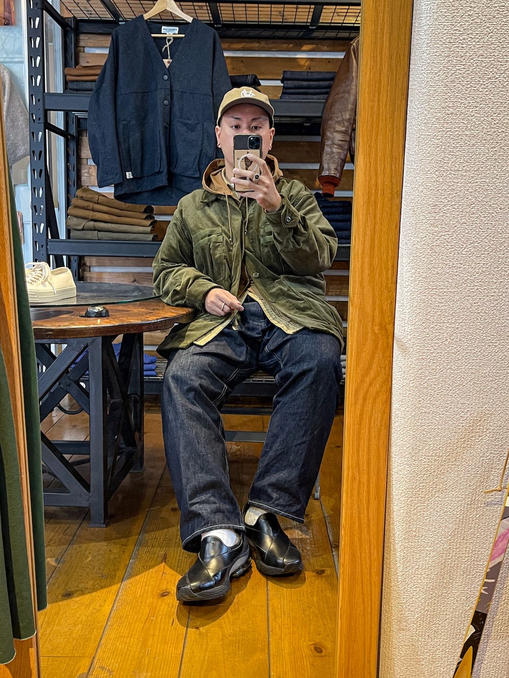 ブラウン系のナイロンジャケット、グリーン系のミリタリージャケット、ブラック系のバッグを着用したメンズの秋コーディネートの2枚目の写真