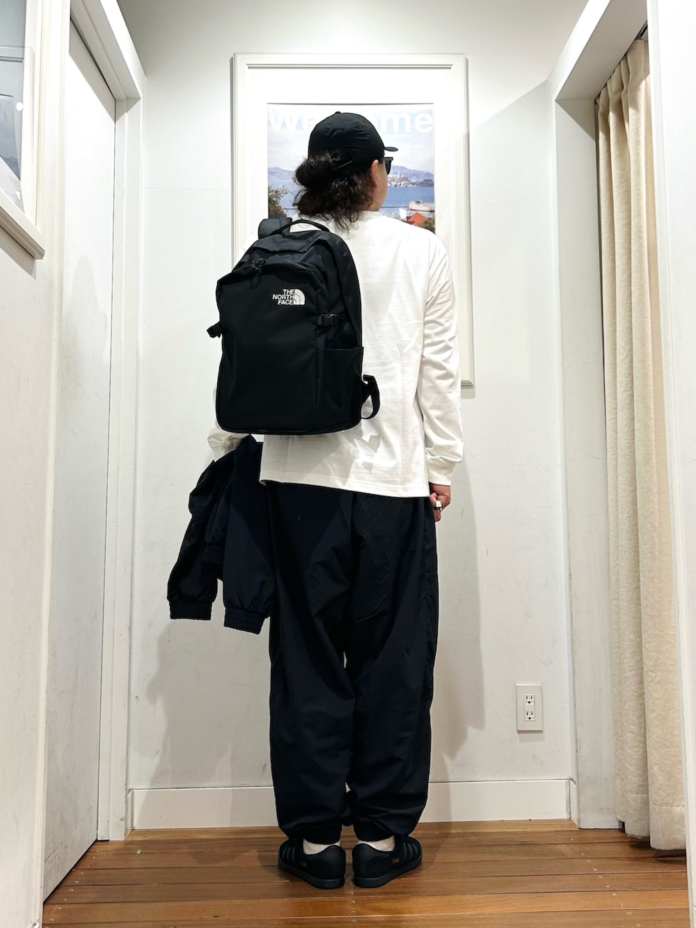 ホワイト系のTシャツ/カットソー、ブラック系のバックパック/リュック、ホワイト系のタンクトップを着用したメンズの夏コーディネートの4枚目の写真