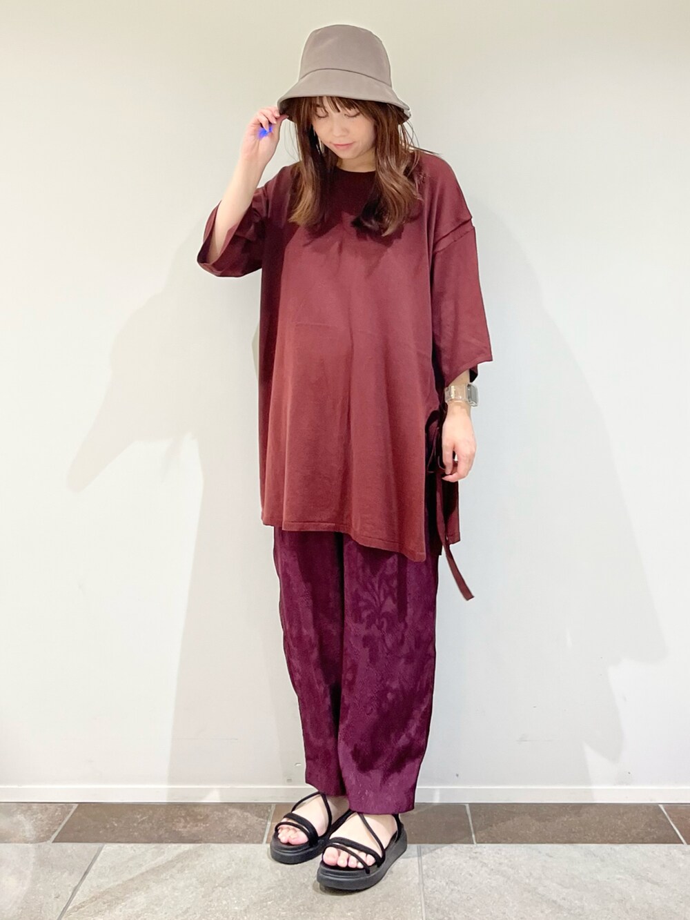 レッド系のニット/セーター、レッド系のその他パンツを着用したレディースの夏コーディネートの2枚目の写真