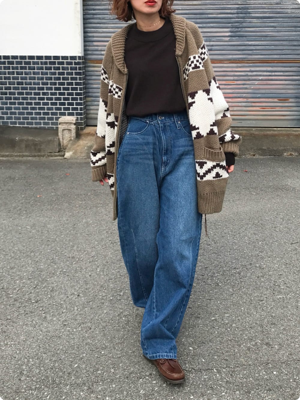 ベージュ系のカーディガン/ボレロ、ブラウン系のTシャツ/カットソー、ブルー系のデニムパンツを着用したレディースの秋コーディネートの2枚目の写真