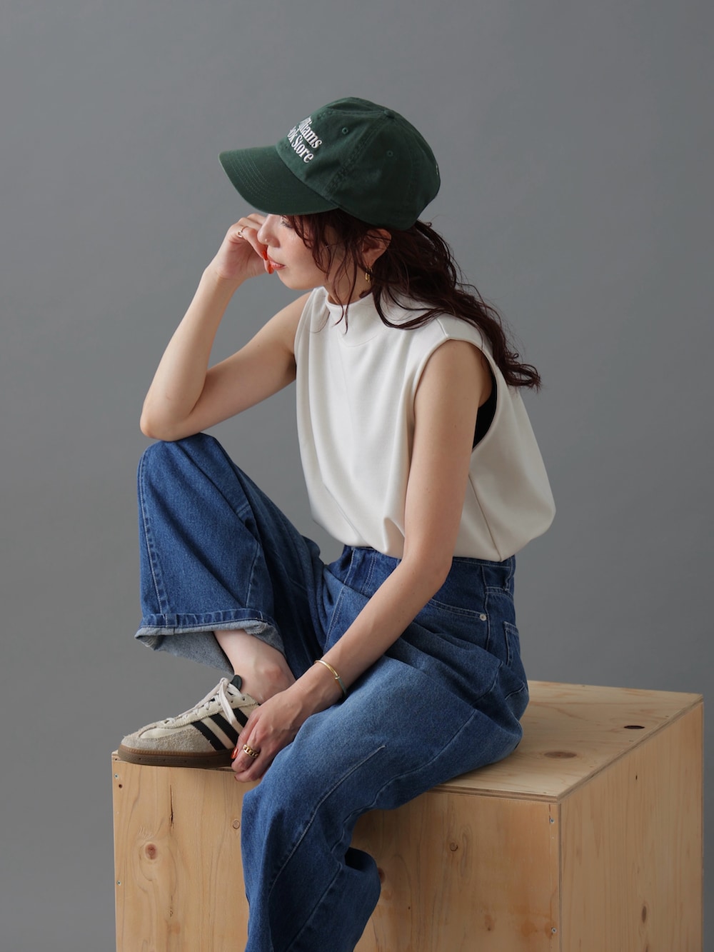 ブルー系のデニムパンツ、ホワイト系のトップス、ホワイト系のスニーカーを着用したレディースの春コーディネートの3枚目の写真