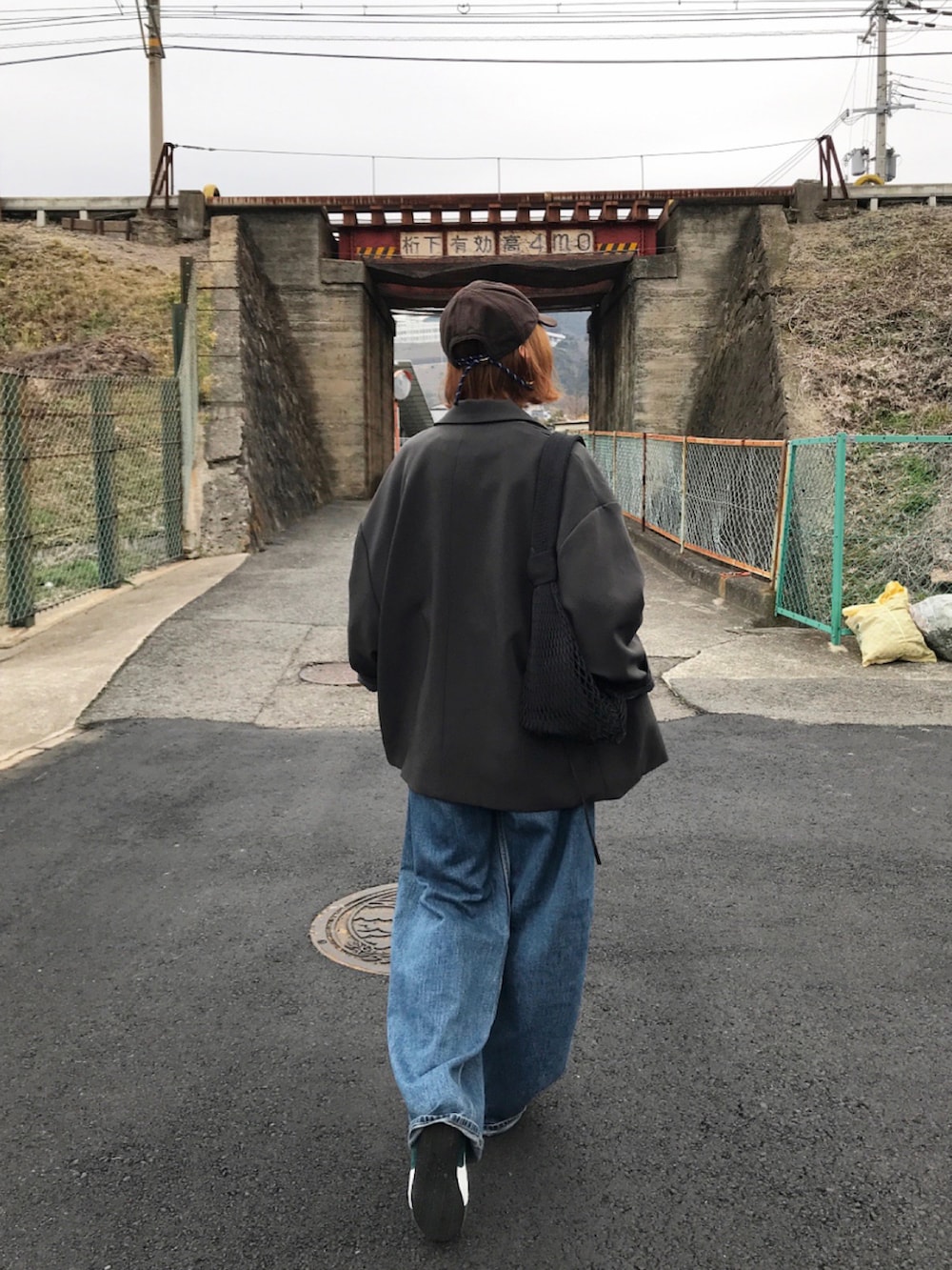 グレー系のテーラードジャケット、グレー系のスウェット、ブルー系のデニムパンツを着用したレディースの冬コーディネートの2枚目の写真