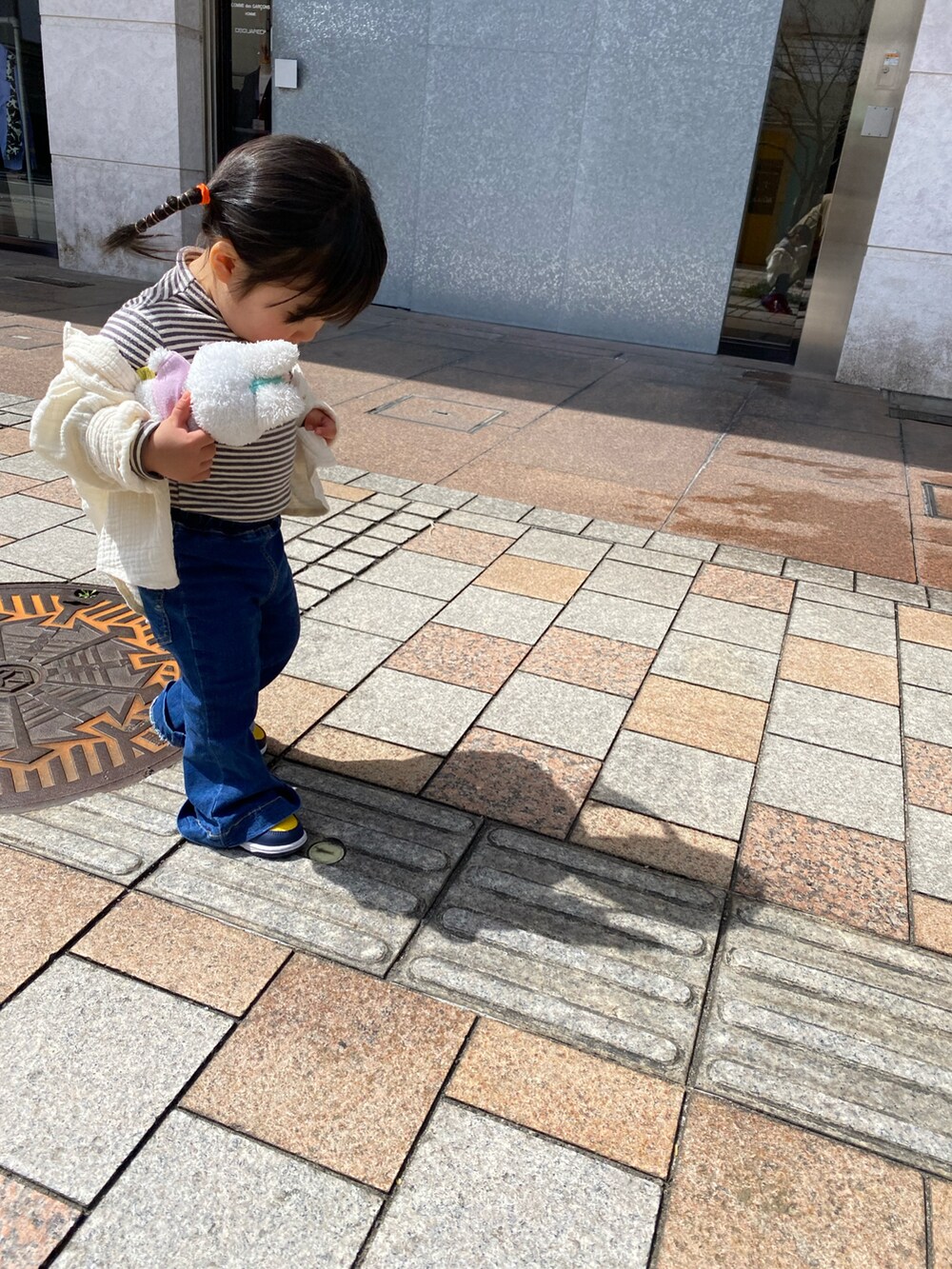 ブルー系のデニムパンツ、ベージュ系のシャツ/ブラウス、イエロー系のスニーカーを着用したキッズの春コーディネートの2枚目の写真