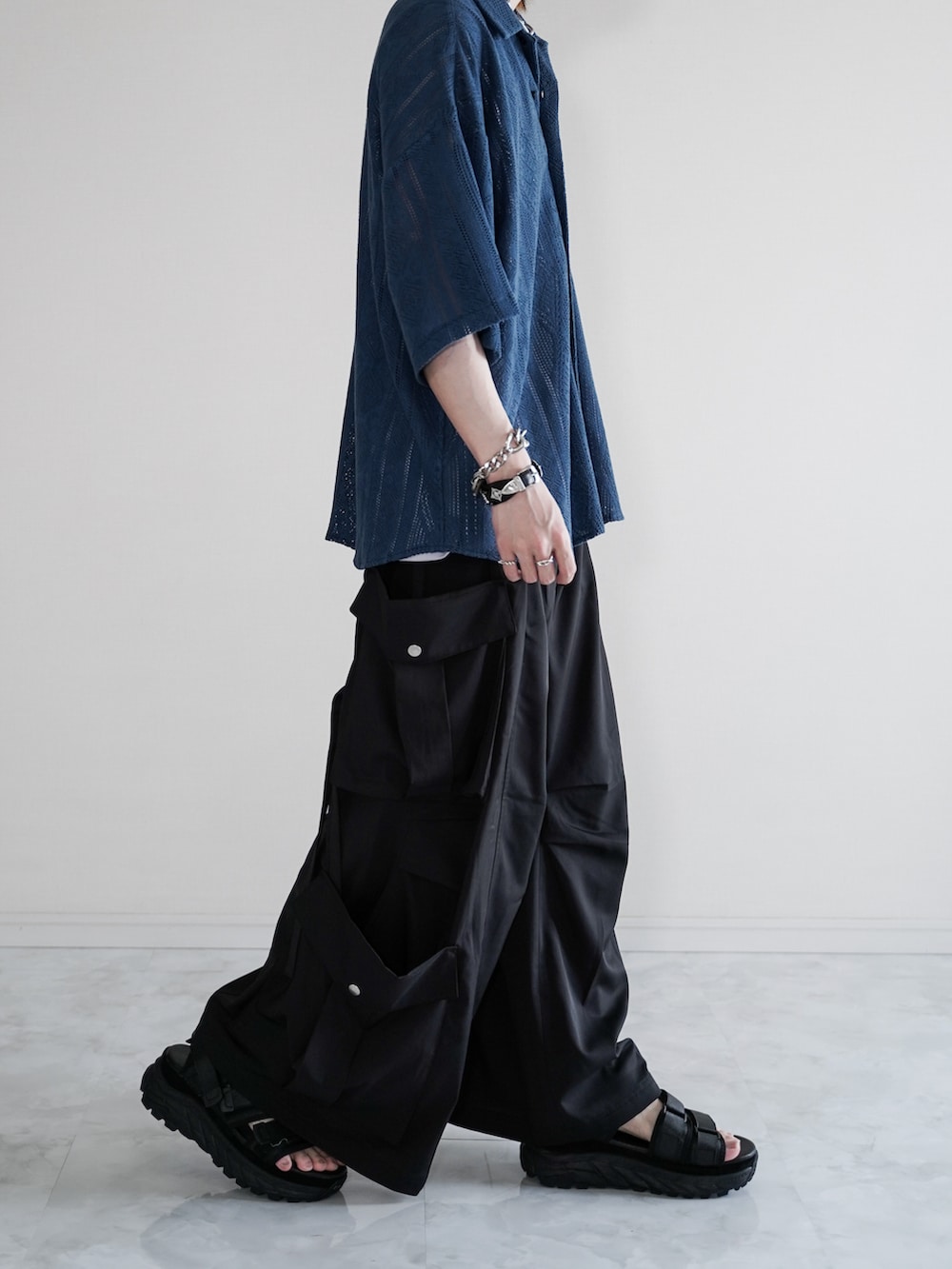 ブルー系のシャツ/ブラウス、ホワイト系のタンクトップ、ブラック系のカーゴパンツを着用したメンズの夏コーディネートの3枚目の写真