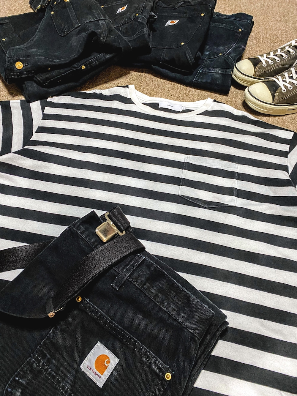 ホワイト系のTシャツ/カットソー、ブラック系のチノパンツ、ブラック系のスニーカーを着用したメンズの秋コーディネートの2枚目の写真