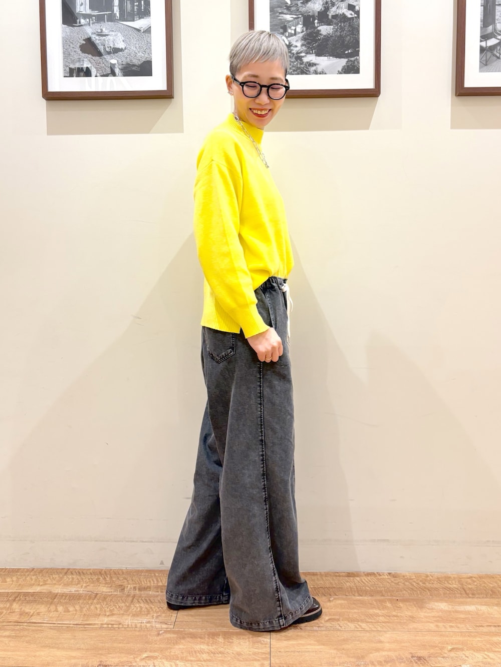 イエロー系のブルゾン、イエロー系のニット/セーター、ブラック系のデニムパンツを着用したレディースの冬コーディネートの6枚目の写真