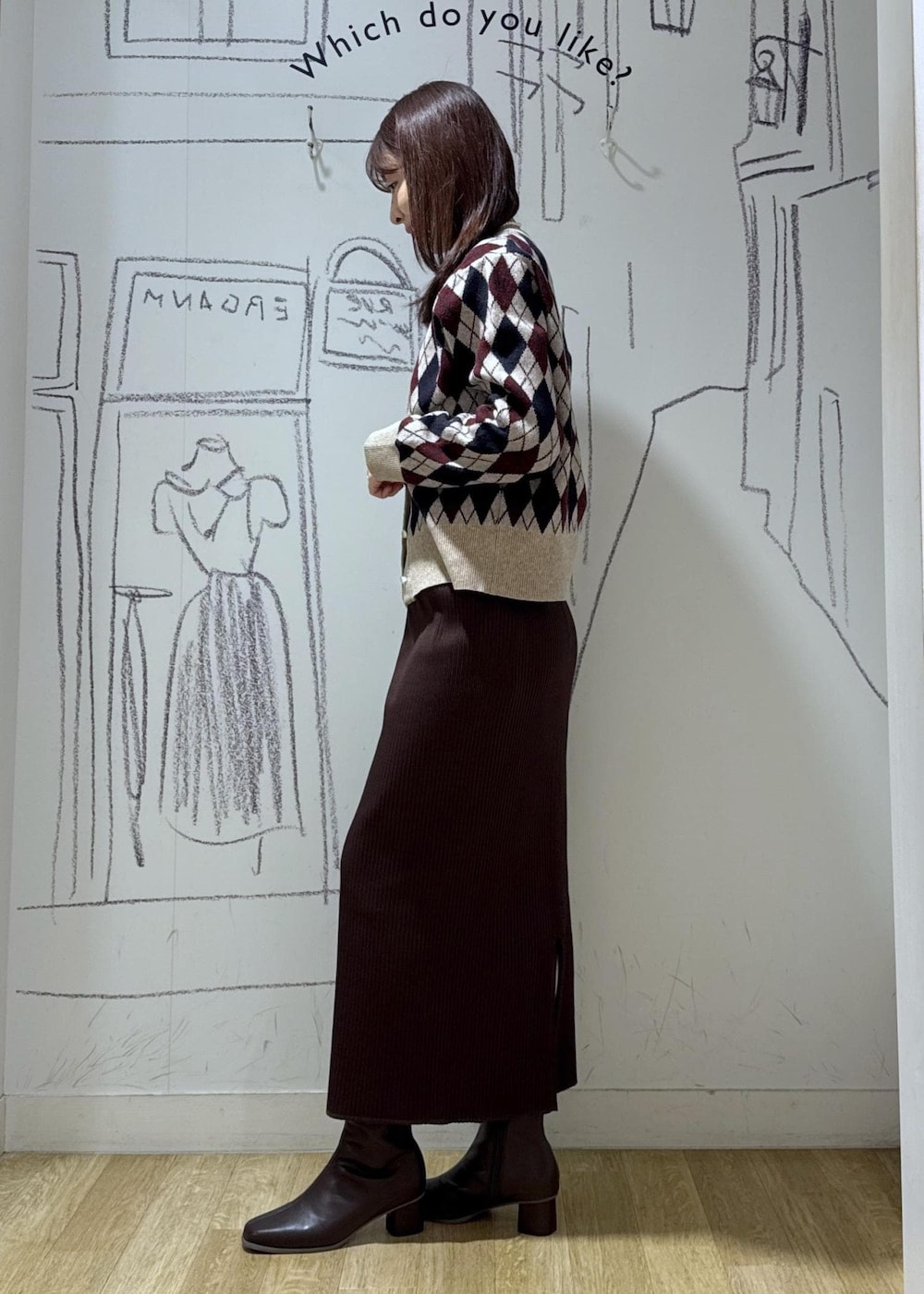 ベージュ系のカーディガン/ボレロ、ブラウン系のブーツ、ブラック系のショルダーバッグを着用したレディースの秋コーディネートの3枚目の写真