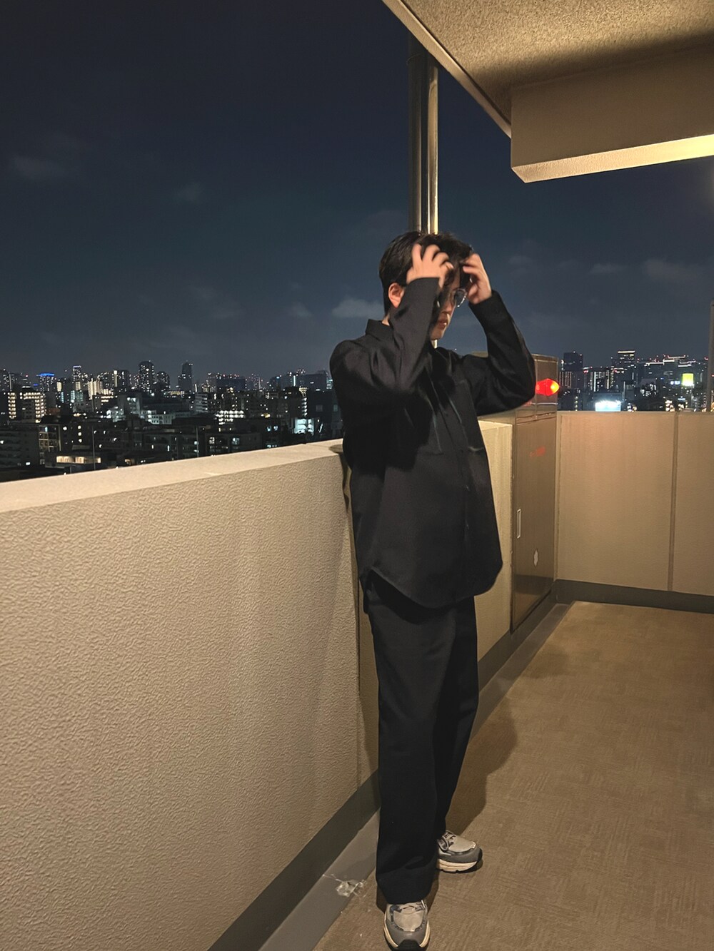 ブルー系のスラックス、グレー系のスニーカー、ブルー系のシャツ/ブラウスを着用したメンズの春コーディネートの2枚目の写真