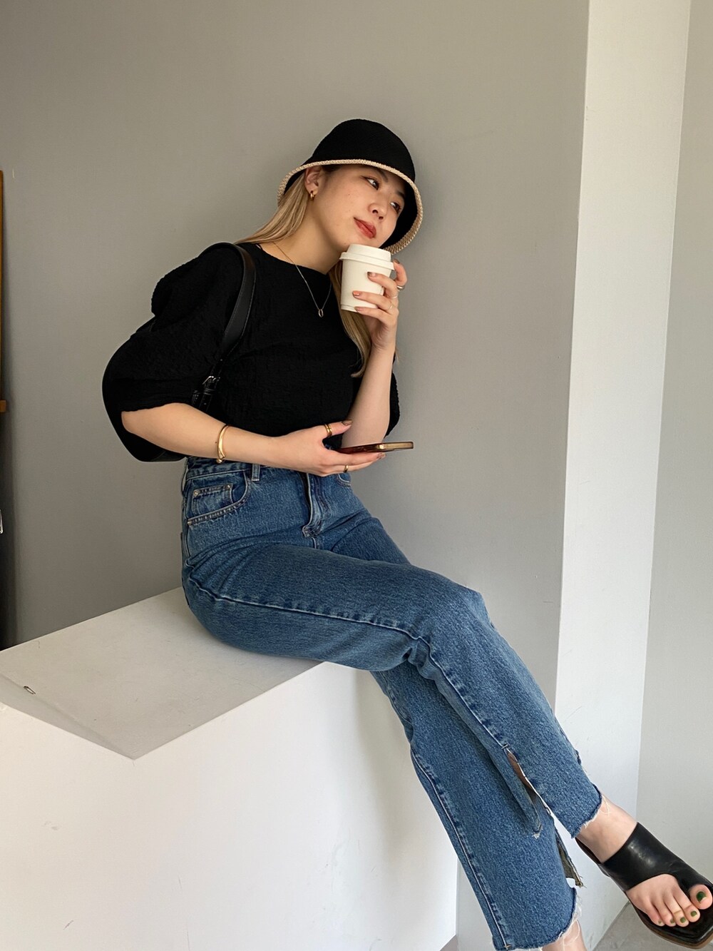 ブラック系のTシャツ/カットソー、ブルー系のデニムパンツ、ブラック系のシューズを着用したレディースの春コーディネートの4枚目の写真