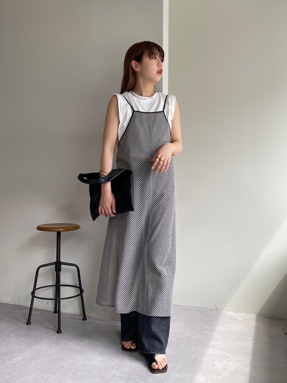 グレー系のワンピース/ドレス、ブラック系のデニムパンツ、ブラック系のシューズを着用したレディースの春コーディネートの2枚目の写真