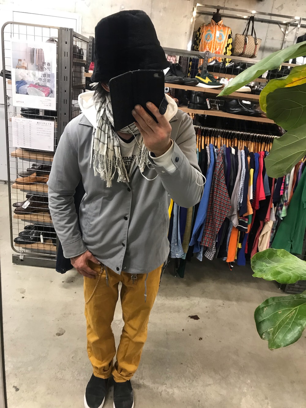 イエロー系のチノパンツ、ブラック系のスリッポン、グレー系のその他アウターを着用したメンズの春コーディネートの2枚目の写真