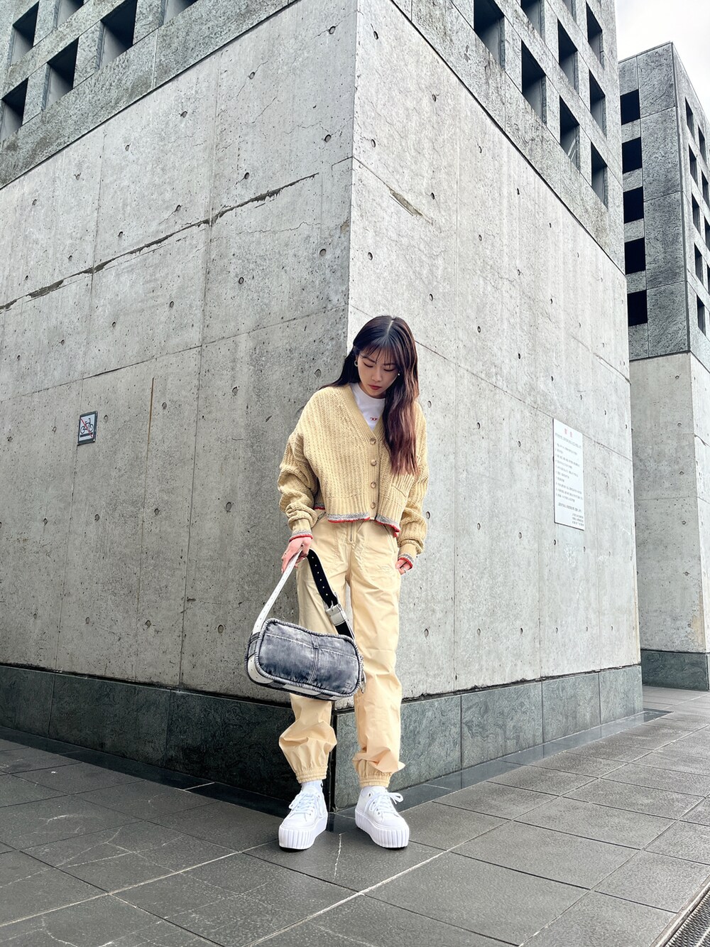 ホワイト系のカーゴパンツ、その他のスニーカー、ブラック系のハンドバッグを着用したレディースの冬コーディネートの2枚目の写真